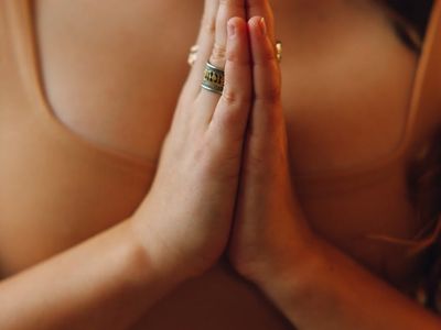 Close-up of hands in a meditative gesture during practice.