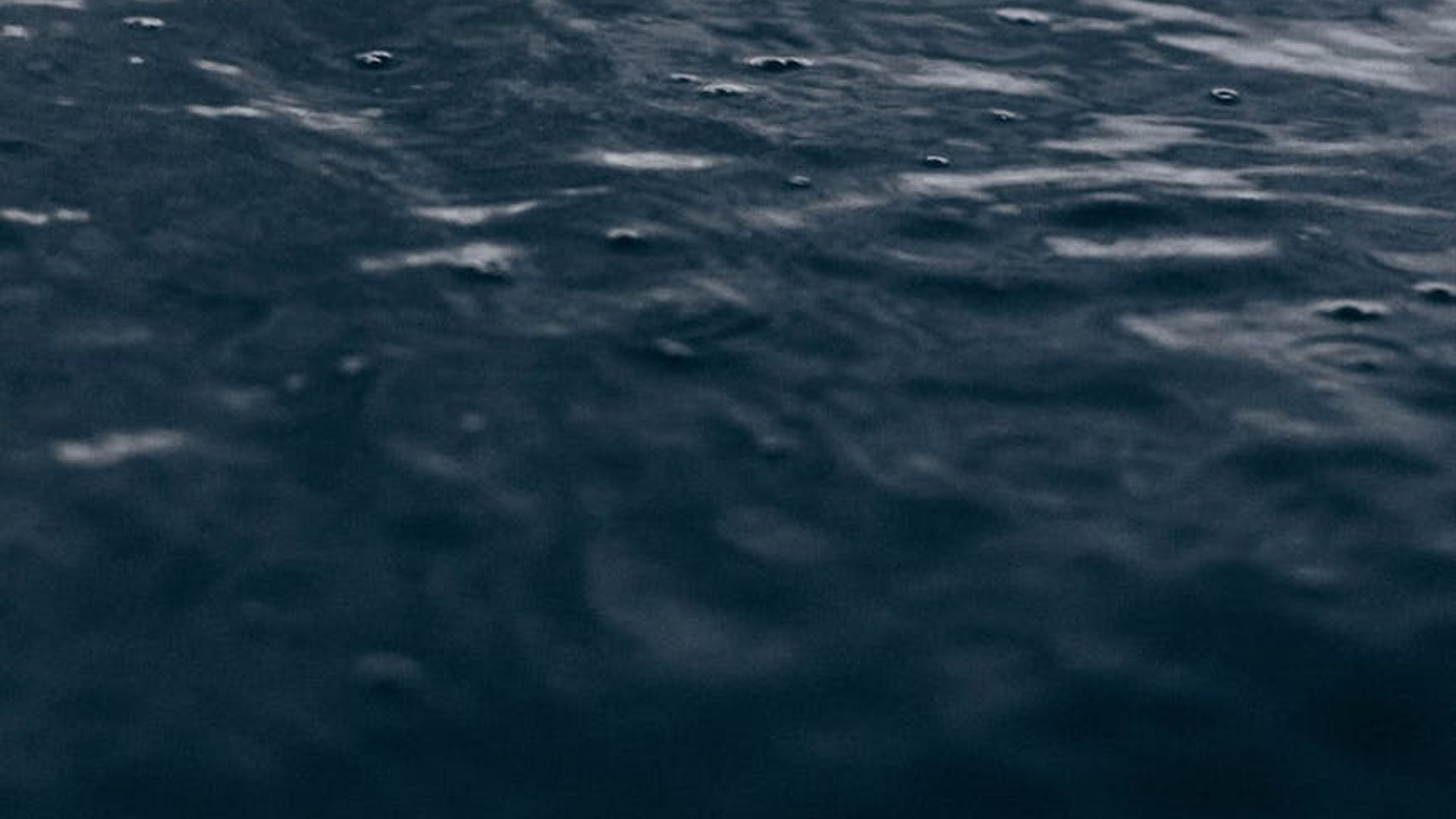 Serene background symbolizing harmony and flow with dark tones.